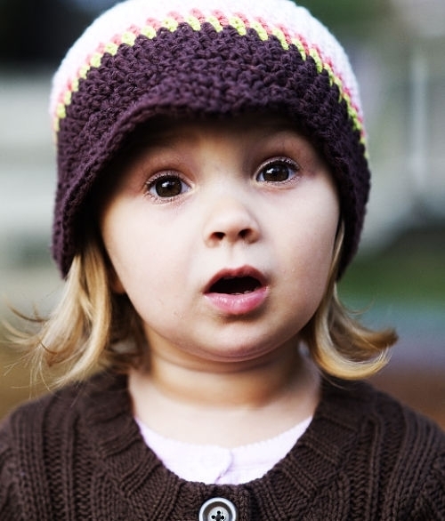 Surprised girl in a cute hat.