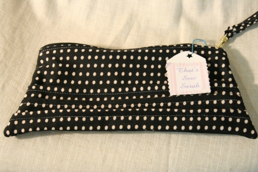 navy and white polka dot clutch bag