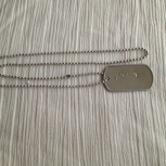 Braille dog tag necklace with word "Dad"