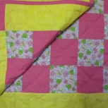 patchwork pink squares and yellow baby quilt