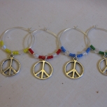 Each wine glass ring has different coloured beads on either side of the peace signs