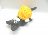 Black playful cat with yarn