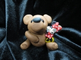 Brown bear sculpture with Minnie Mouse