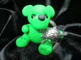 Green bear sculpture with silver sea turtle