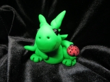 Green dragon sculpture with a lady bug