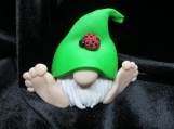 Green hat gnome figurine with a lady bug