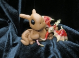 Polymer clay brown dragon sculpture with a flying dragon