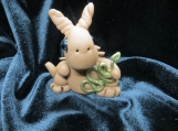 Polymer clay dragon sculpture with a gold snake