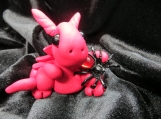 Red dragon figurine with a spider