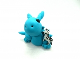 Turquoise dragon figurine with a zebra