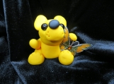 Yellow bear figurine with an orange butterfly
