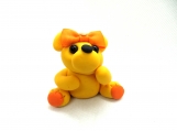 Yellow bear with an orange bow
