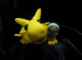 Yellow dragon sculpture with a sugar skull