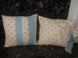 Stunning cream and pink polka dot cushion with blue trim