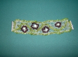 Silver wire crochetted bracelet with peridot and garnet beads