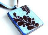 Brown fern on blue texture background wood pendant