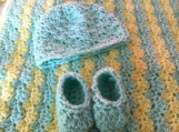 yellow and green baby blanket with booties and hat