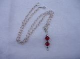 An adjustable length red/silver crystal necklace.