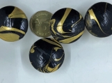 A set of 4 black and gold marbled knobs.