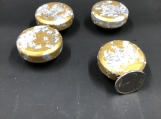 A shiny gold and silver flake set of 4 knobs.