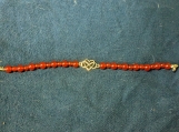 Infinity heart bracelet with red beads