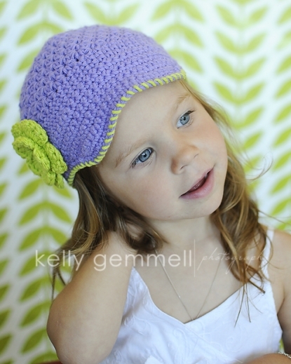 Purple newsboy hat with flower embellishment