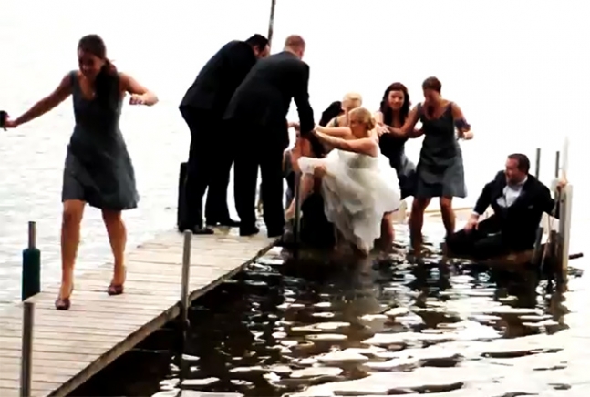 Wedding photos, bridal party well into water while taking photos.