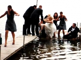 Wedding photos, bridal party well into water while taking photos.