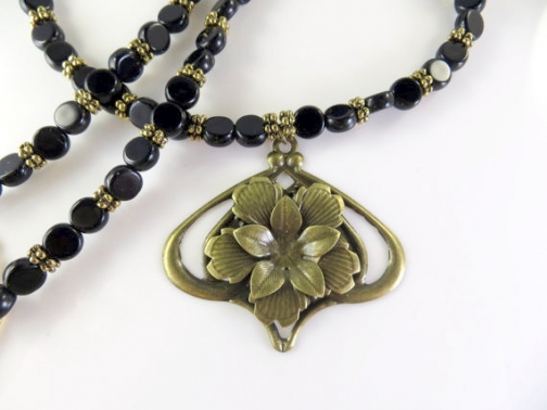 Black beaded necklace with gold pendant